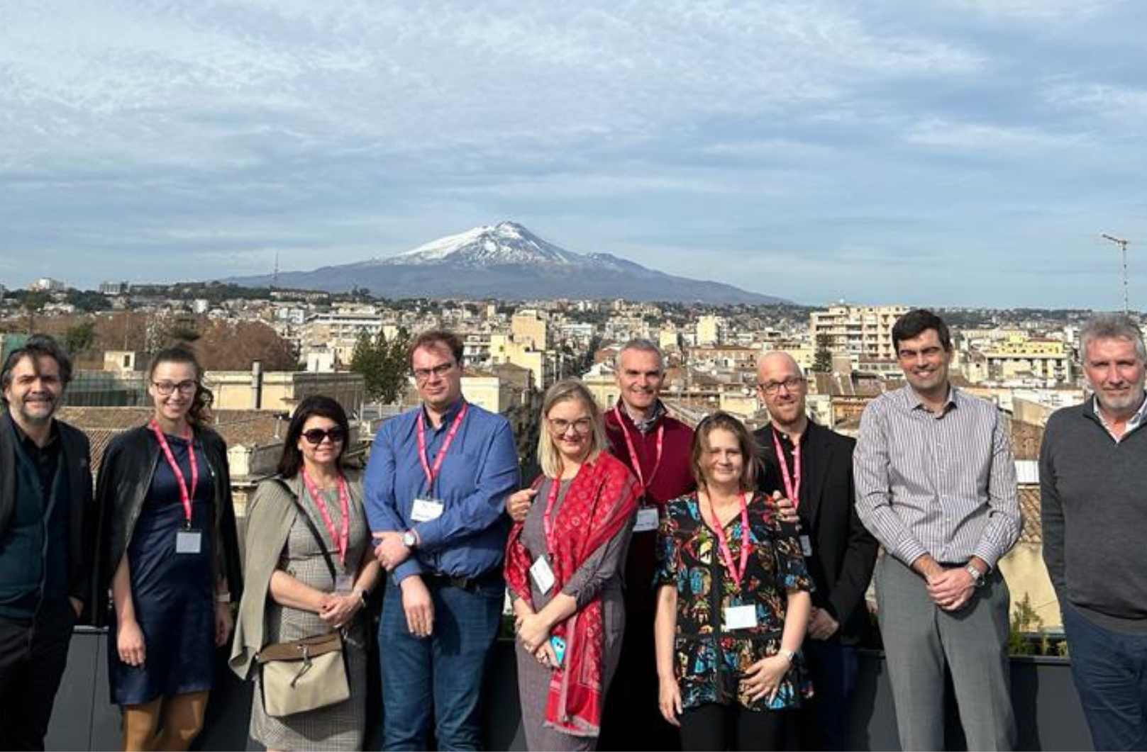Group of researchers from CoEHAR posing in front of the mountain in Catania